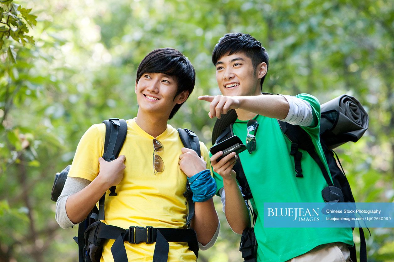 Chinese hikers using mobile phone with GPS