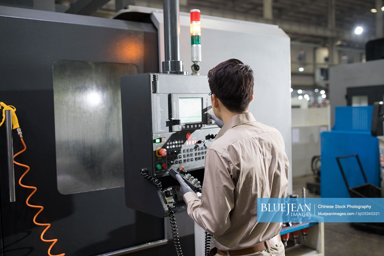 Male Chinese engineer working in the factory