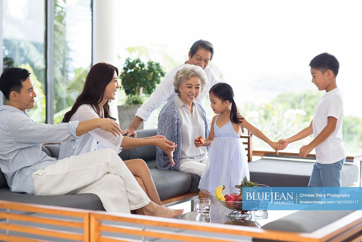 Happy Chinese family relaxing on the sofa