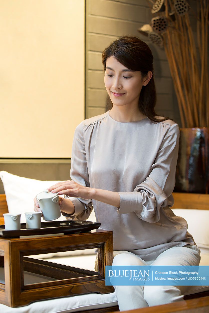 Young Chinese woman performing tea ceremony