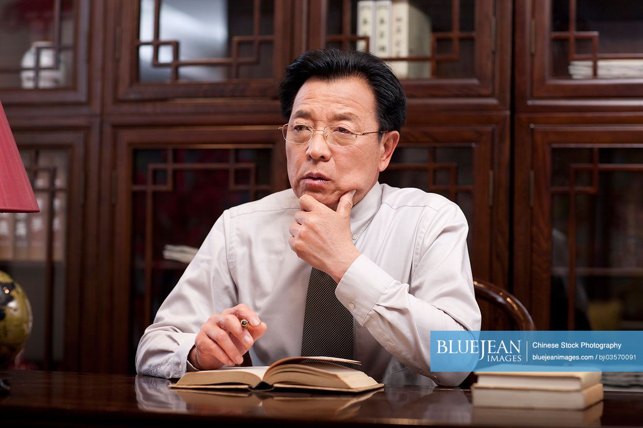 Chinese businessman reading a book