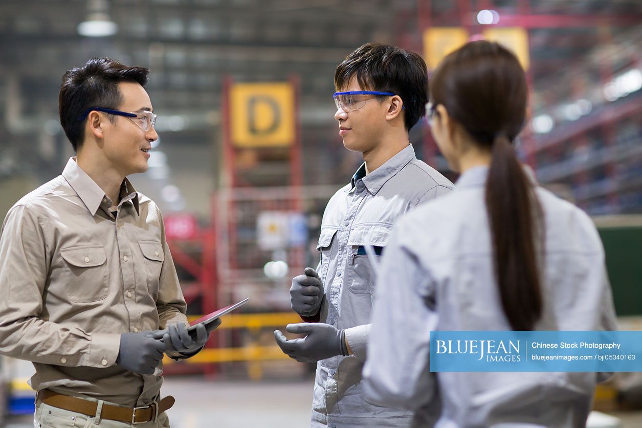 Confident Chinese engineers talking in the factory-High-res stock photo ...