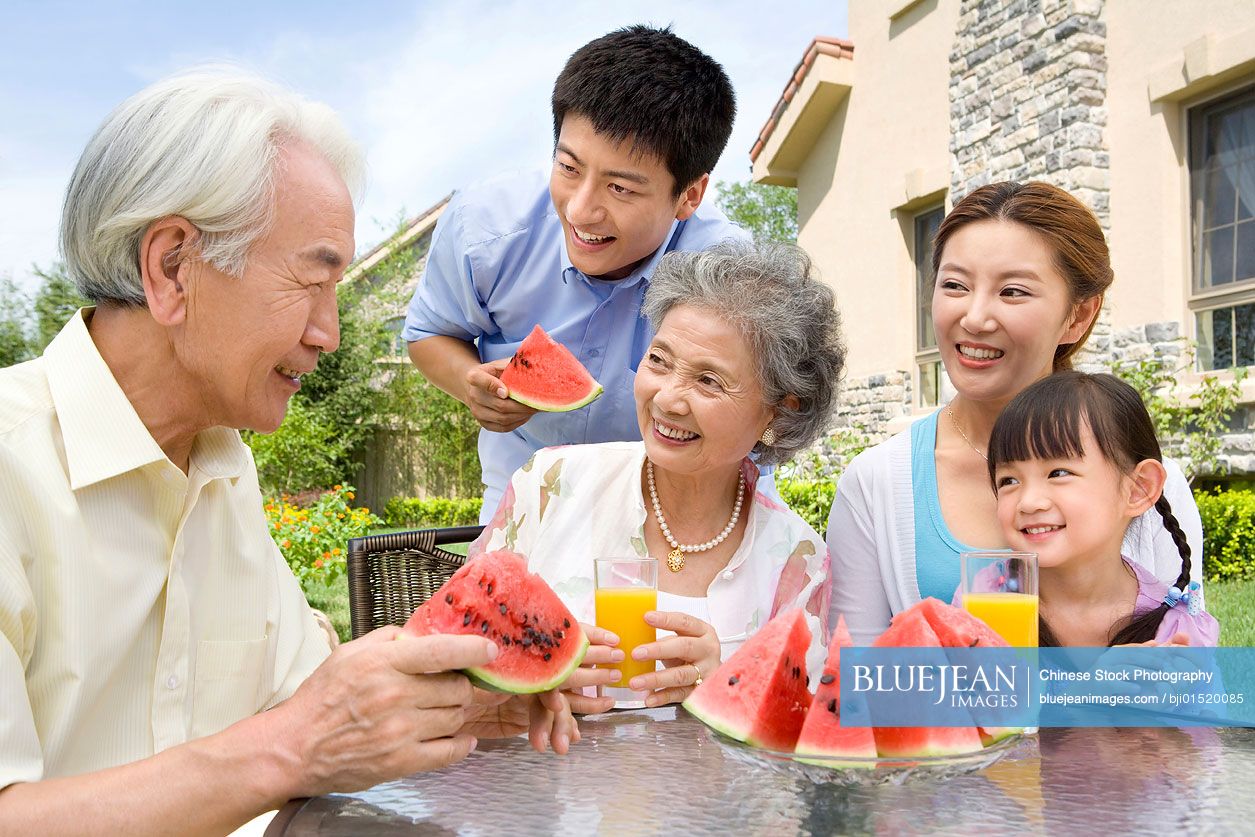 Chinese family eating watermelon