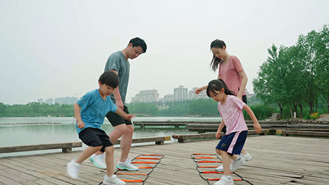 A young family works out in the park, staying active and healthy