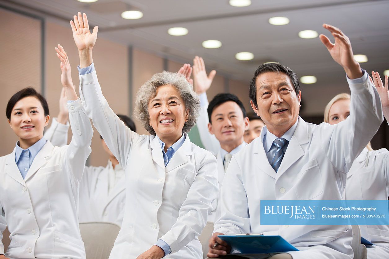 Chinese medical workers raising hands