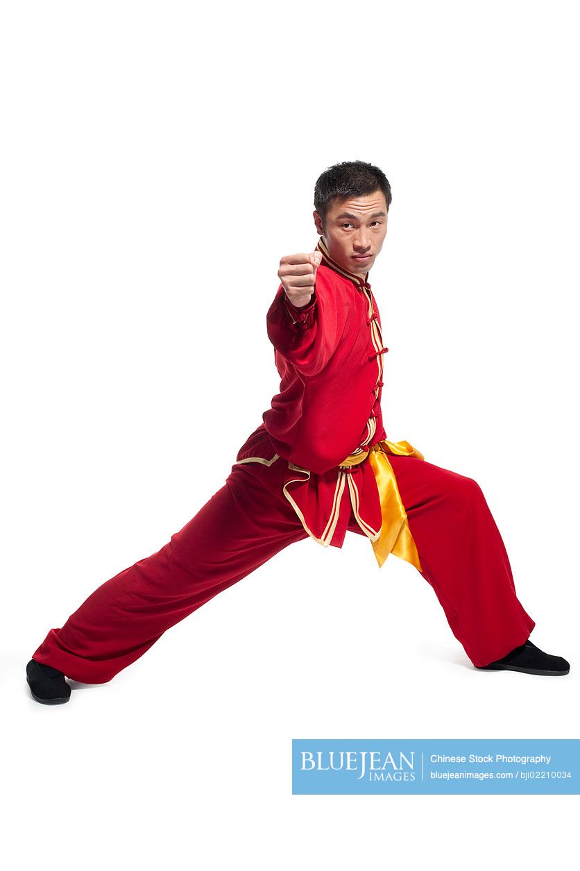 Focused Chinese man doing martial arts in traditional clothing