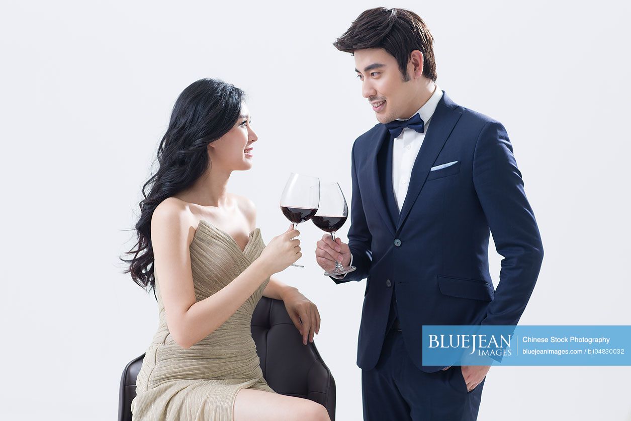 Elegant young Chinese couple enjoying red wine-High-res stock photo for ...