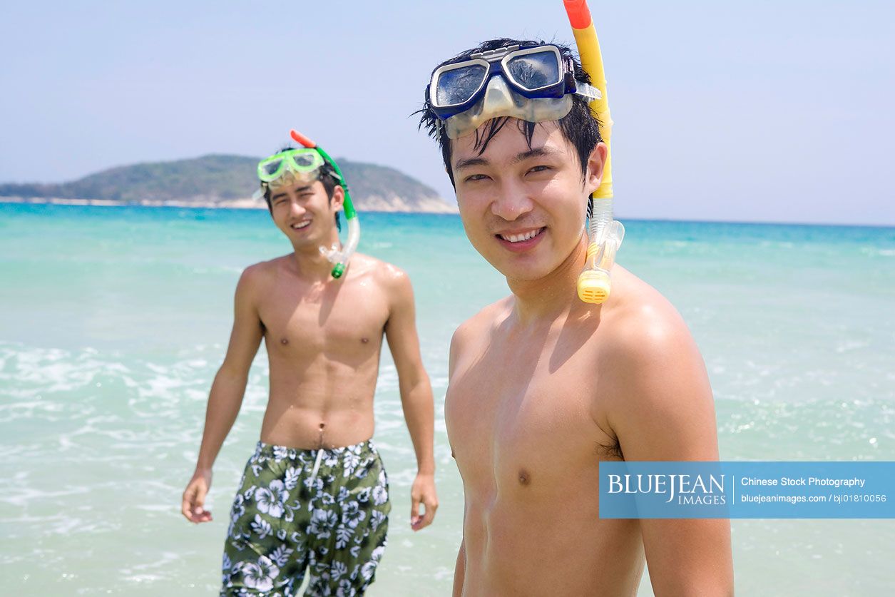 Young Chinese men wearing snorkel gear