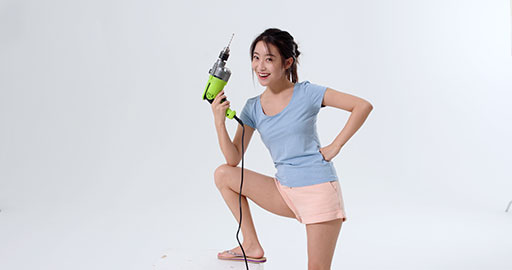 Cheerful young Chinese woman holding a hand drill,4K
