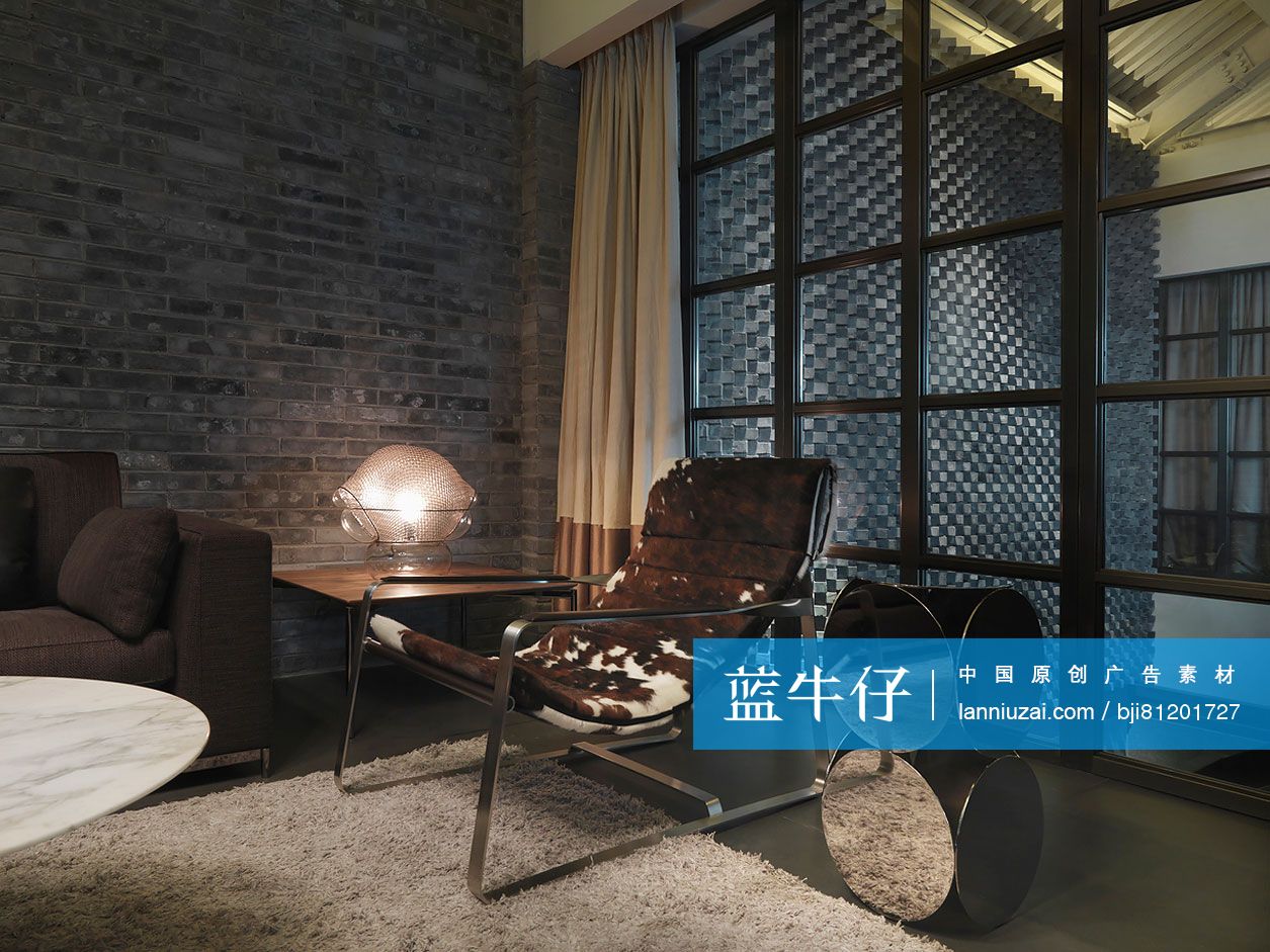 Modern lounge chair by centerpiece in corner of restaurant