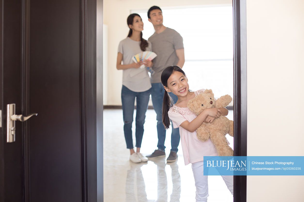 Happy young Chinese family working on home renovation