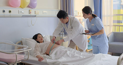 Chinese doctor examining pregnant woman in hospital ward,4K