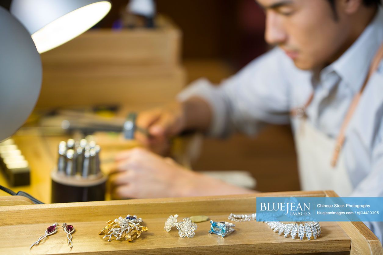 Chinese male jeweler working in studioHighres stock photo for download