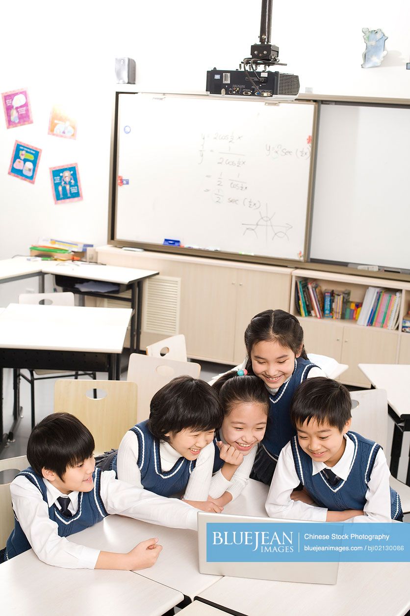 Chinese students gathered around a computer in the classroom