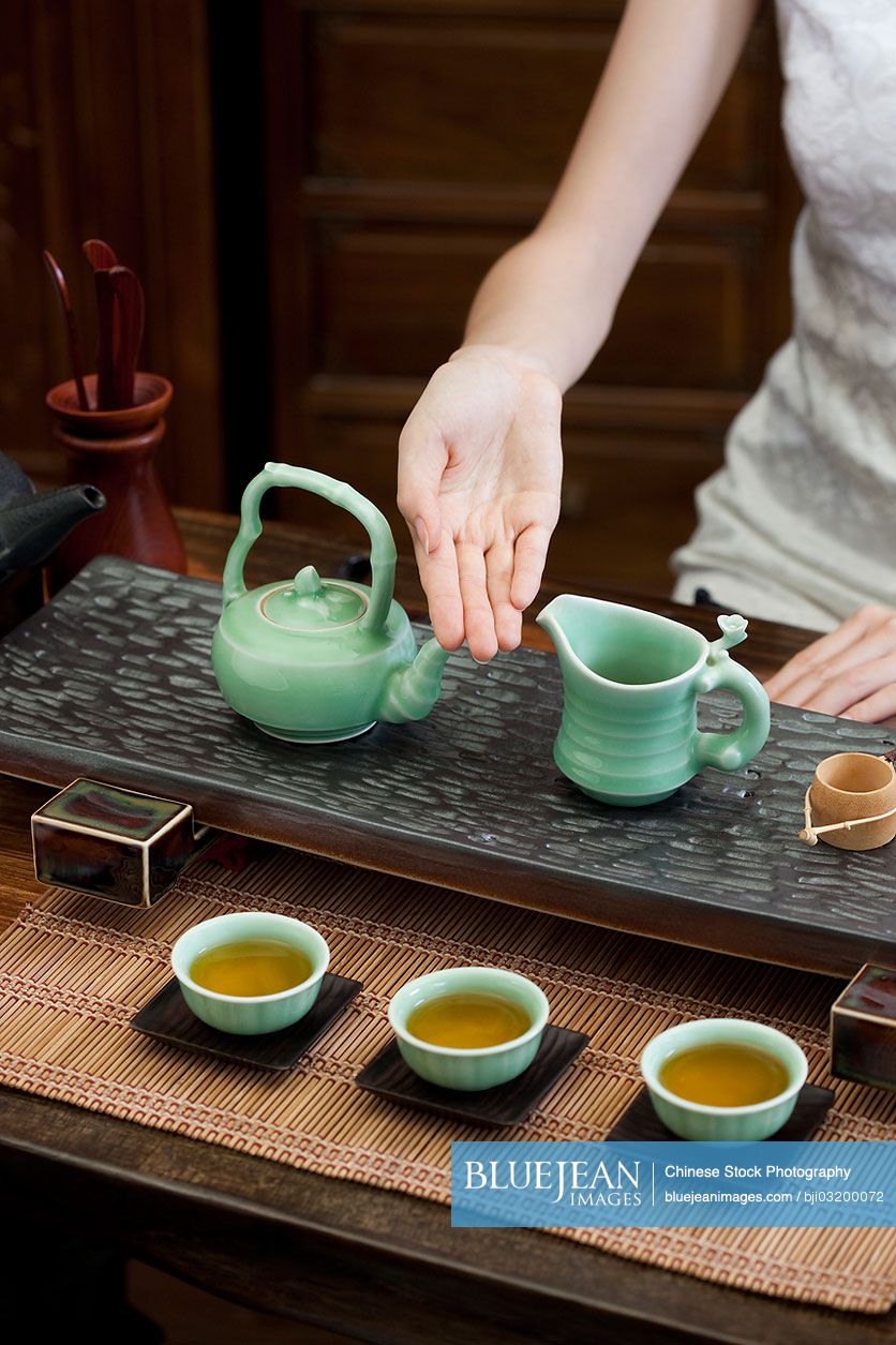 Young Chinese woman performing Chinese tea ceremony