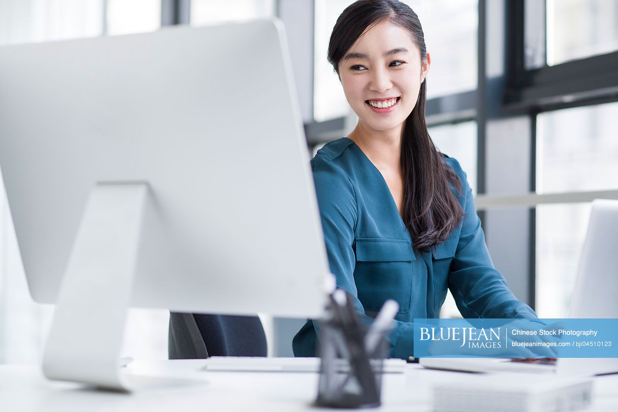 Young Chinese businesswoman working in office