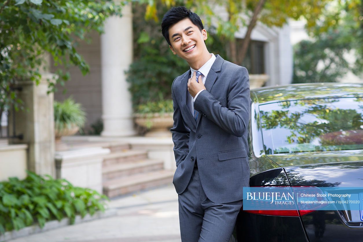 Young Chinese businessman and car