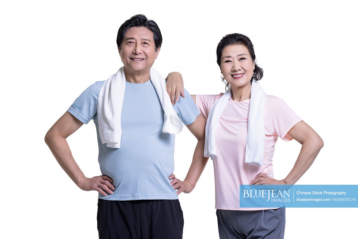 Studio shot of senior Chinese couple exercising