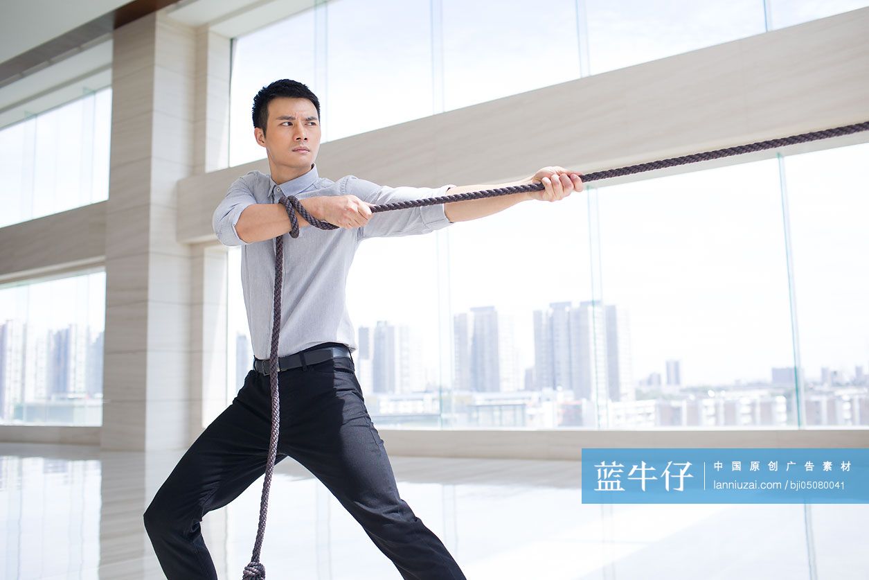 年轻商务男子拔河
