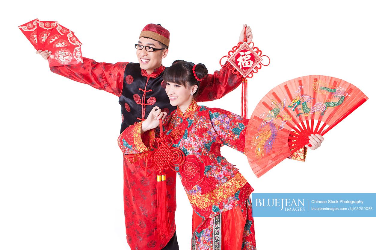 Young couple in traditional clothing celebrating Chinese New Year