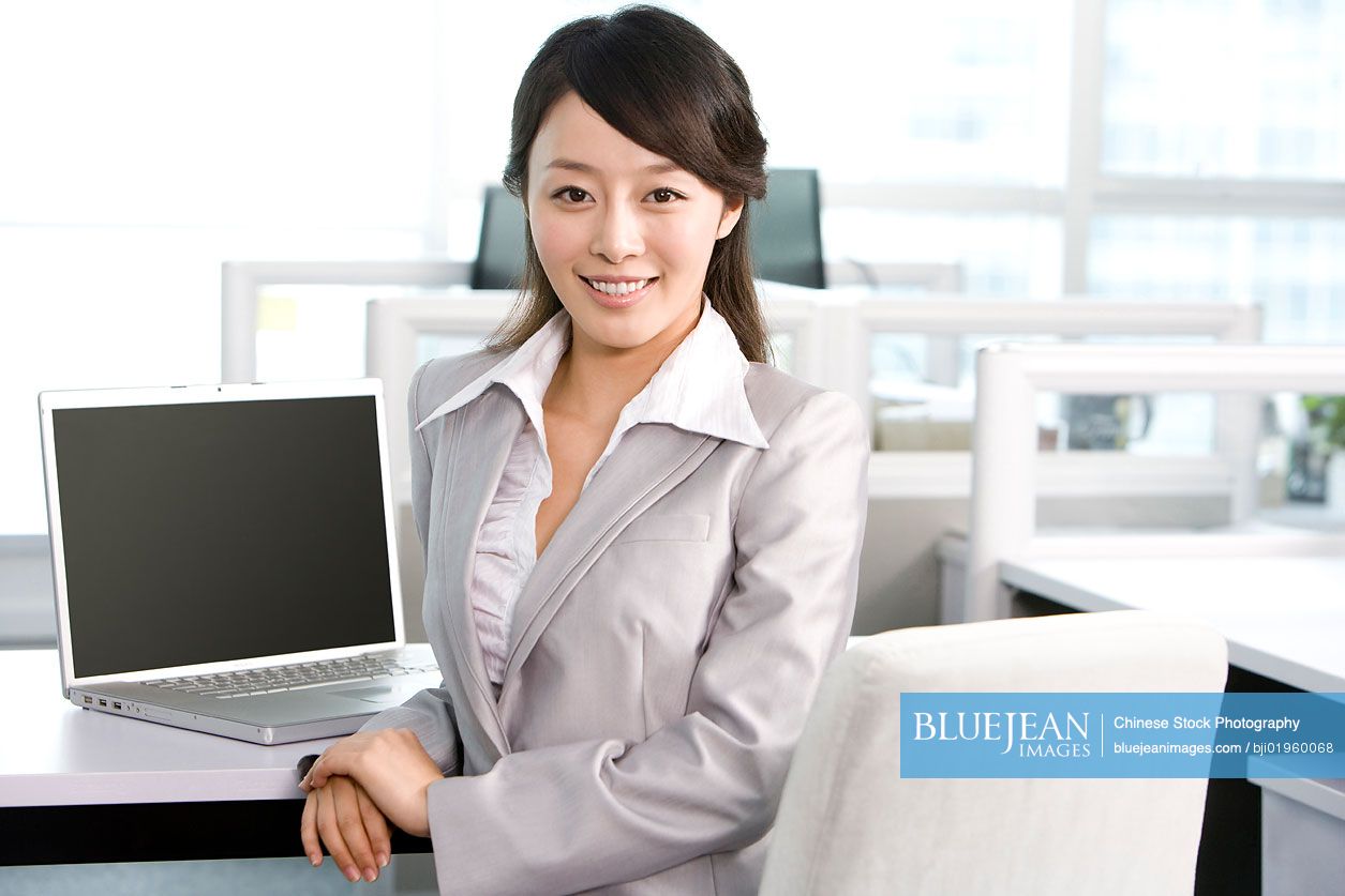 Chinese office worker at her desk
