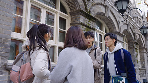 Happy Chinese college students walking and talking