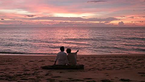 Senior Chinese couple enjoying in sunset on beach,4K