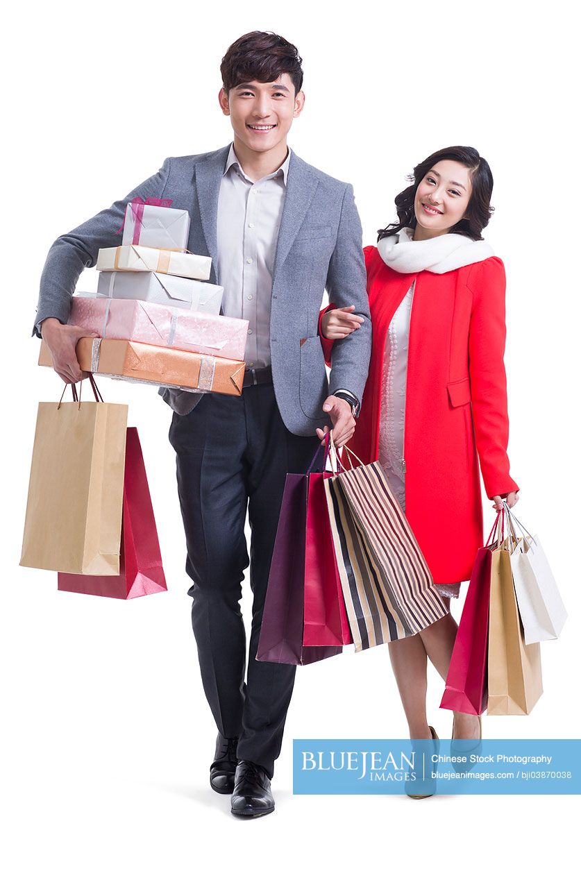 Happy young Chinese couple going shopping