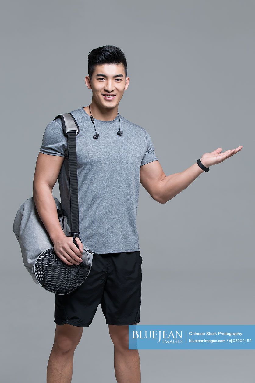 Portrait of cheerful young Chinese male athlete