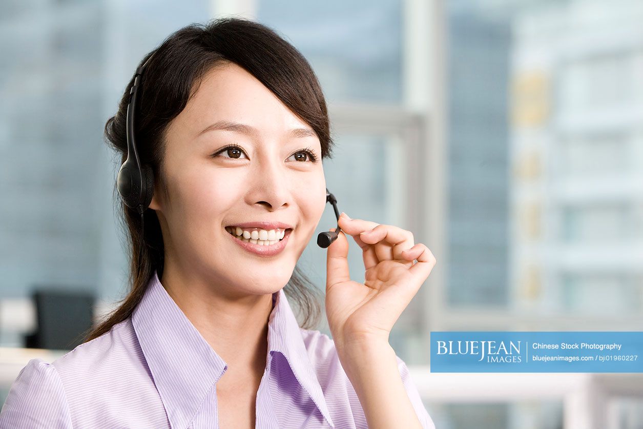 Chinese office worker with a headset