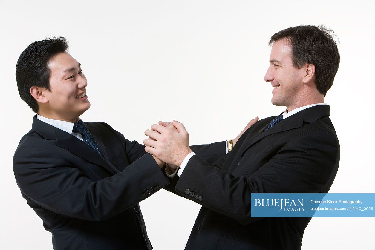 Businessmen holding hands