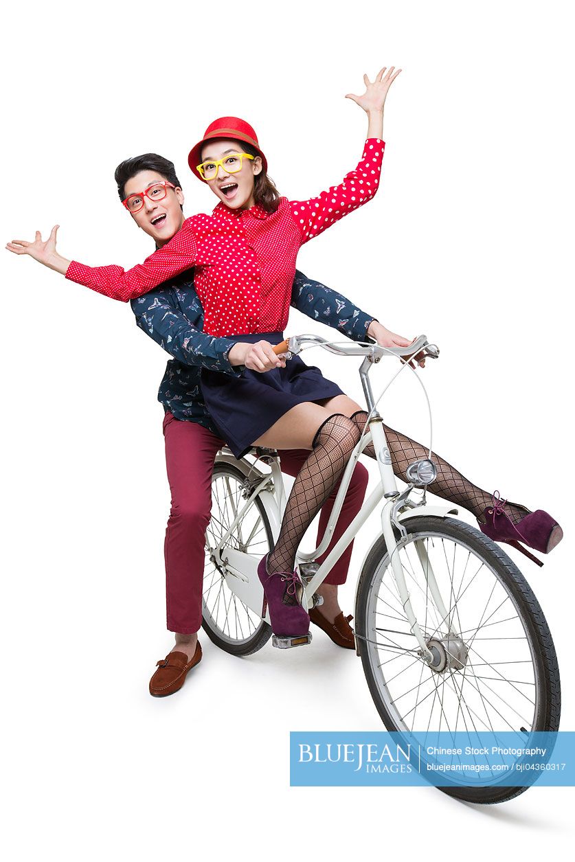 Young Chinese couple riding on a bike