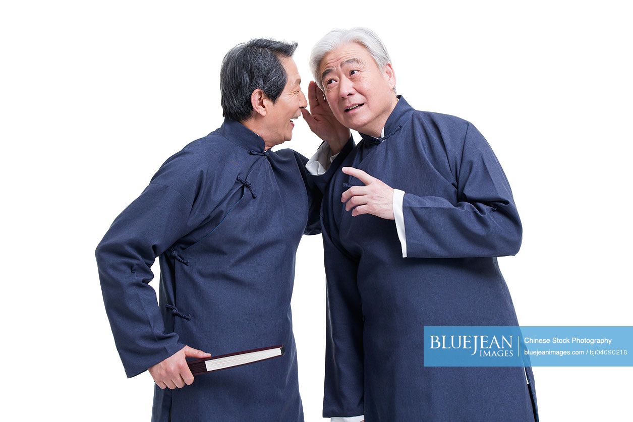 Cheerful senior Chinese men in traditional clothing