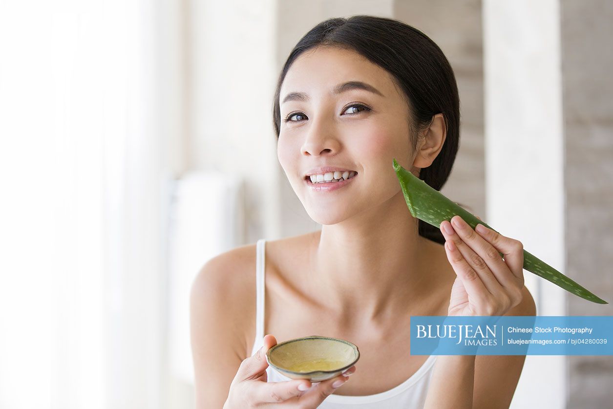 Young Chinese woman with natural aloe vera-High-res stock photo for download