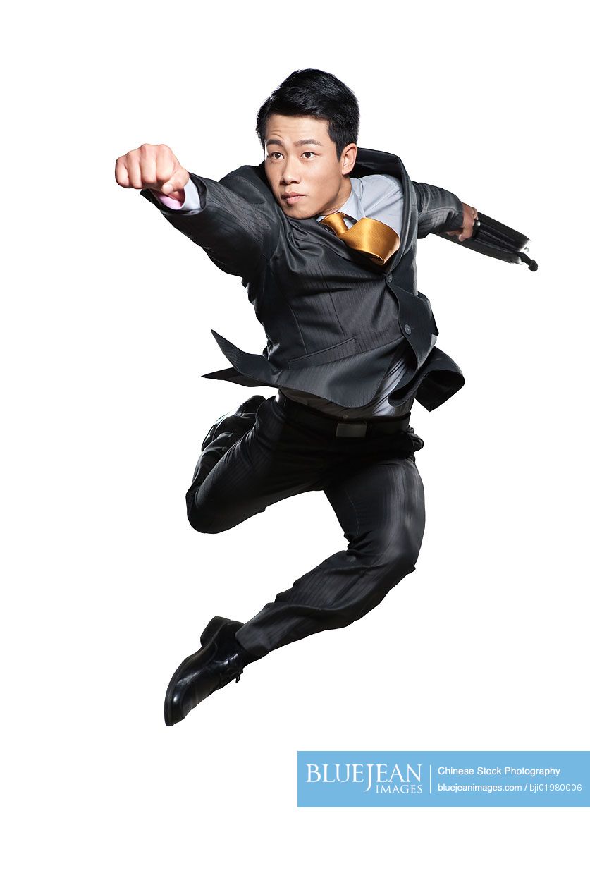 Chinese businessman punching in the air on white background