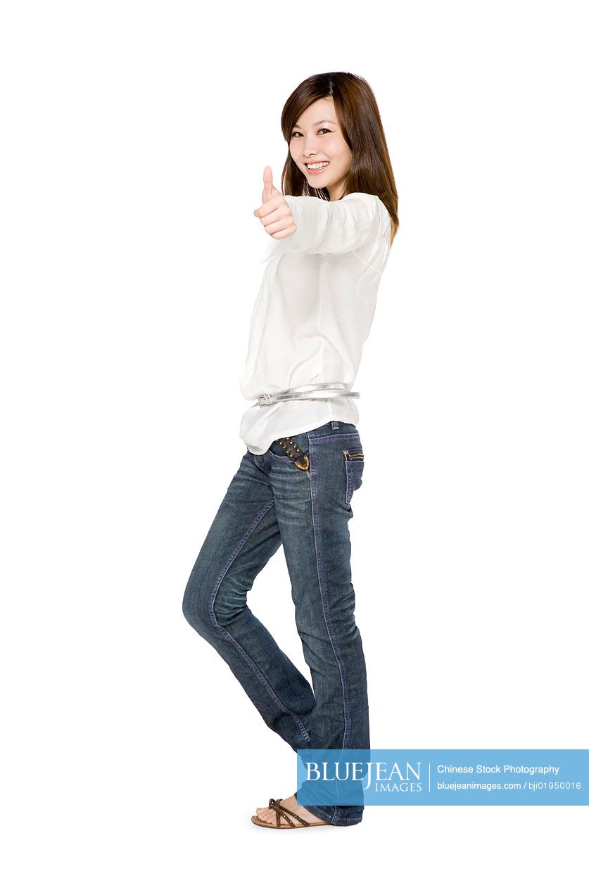 Portrait of young Chinese woman giving thumbs up