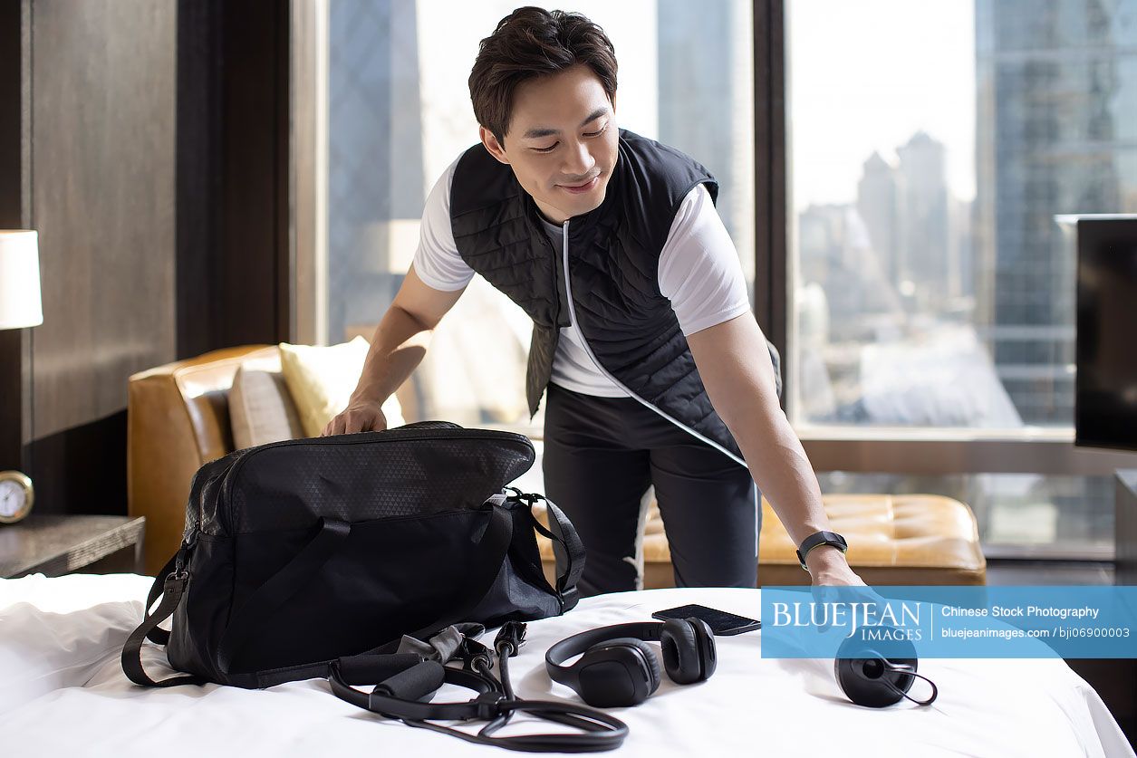 Chinese mid adult man getting ready to go out and workout