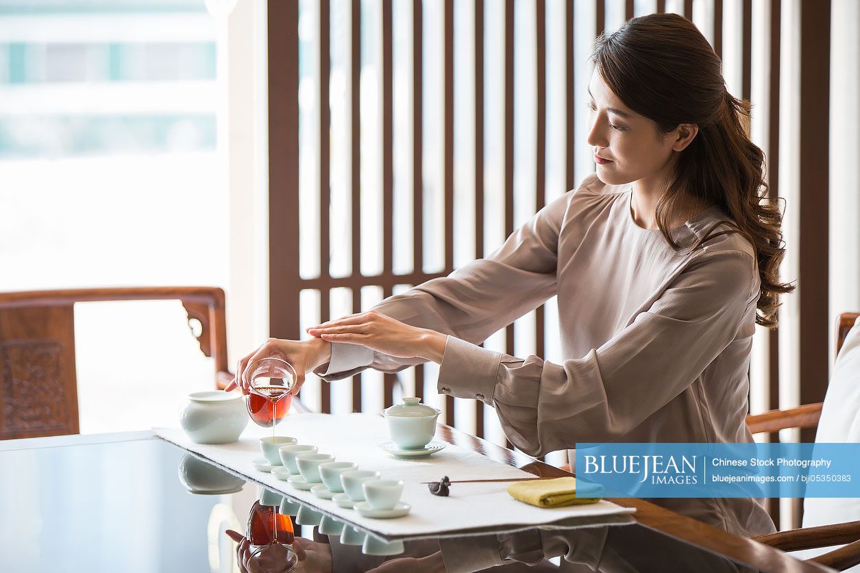 Young Chinese woman performing tea ceremony