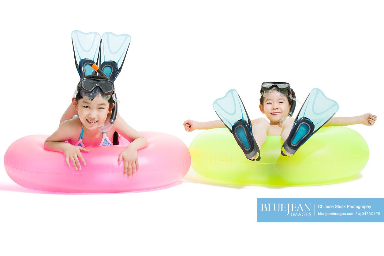 Cute Chinese children in swimsuit with swim rings