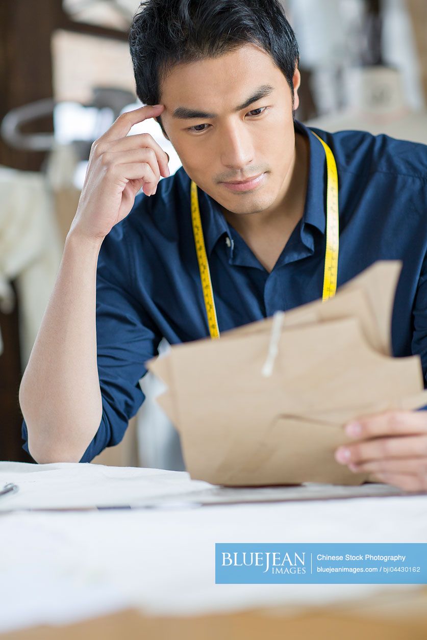 Chinese fashion designer working in studio
