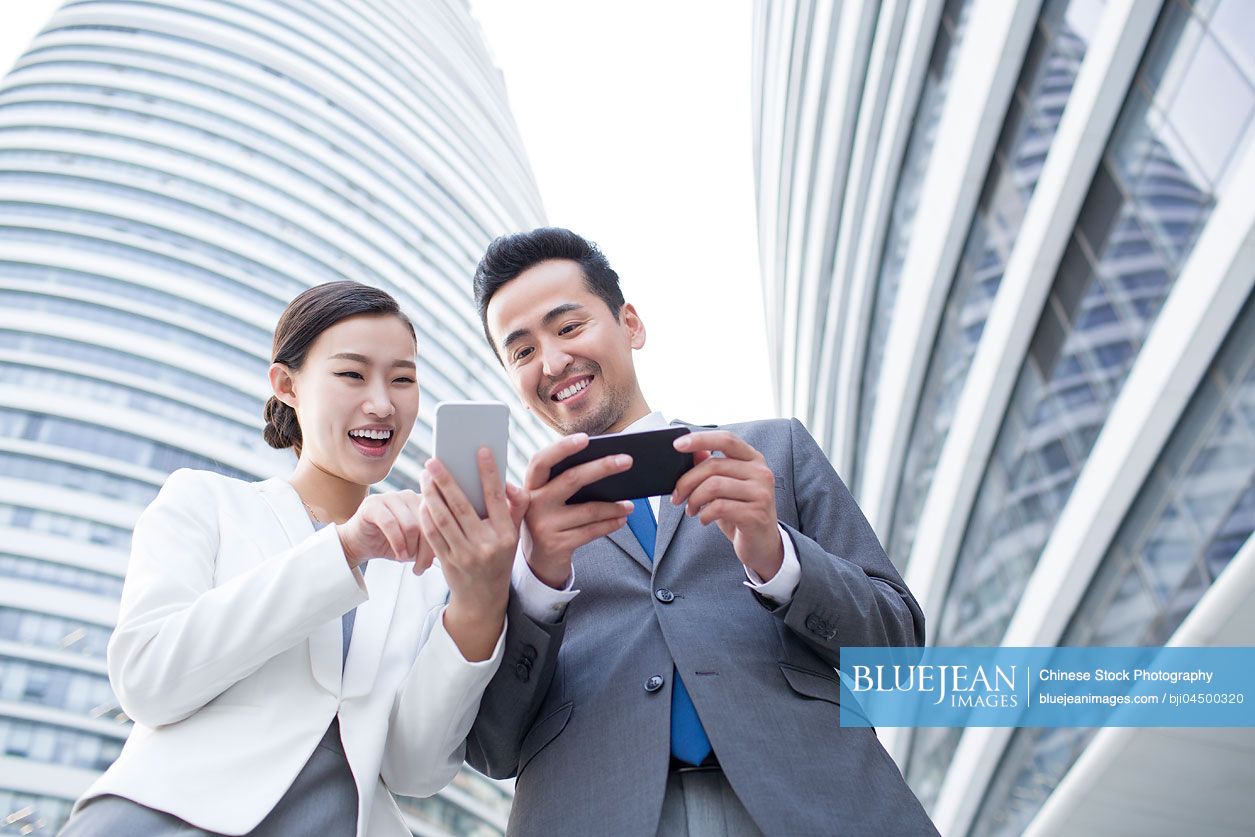 Chinese business person using smart phones