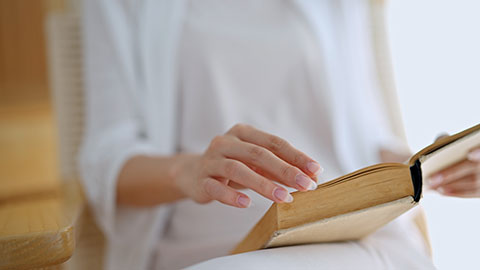 Elegant young Chinese woman reading book at home,4K