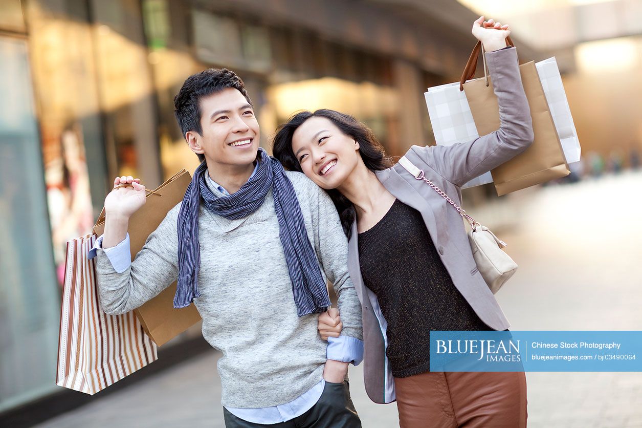 Fashionable young Chinese couple shopping