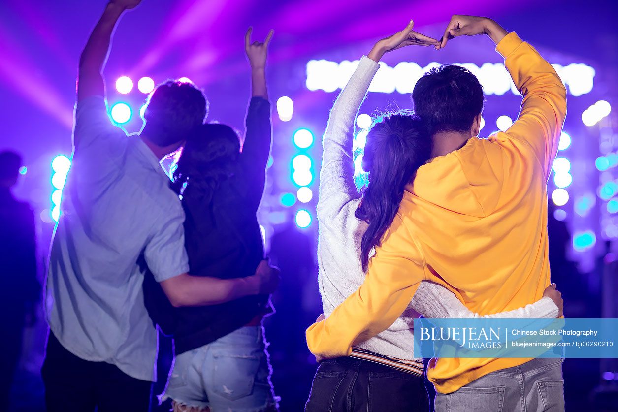 Happy young Chinese friends at music festival