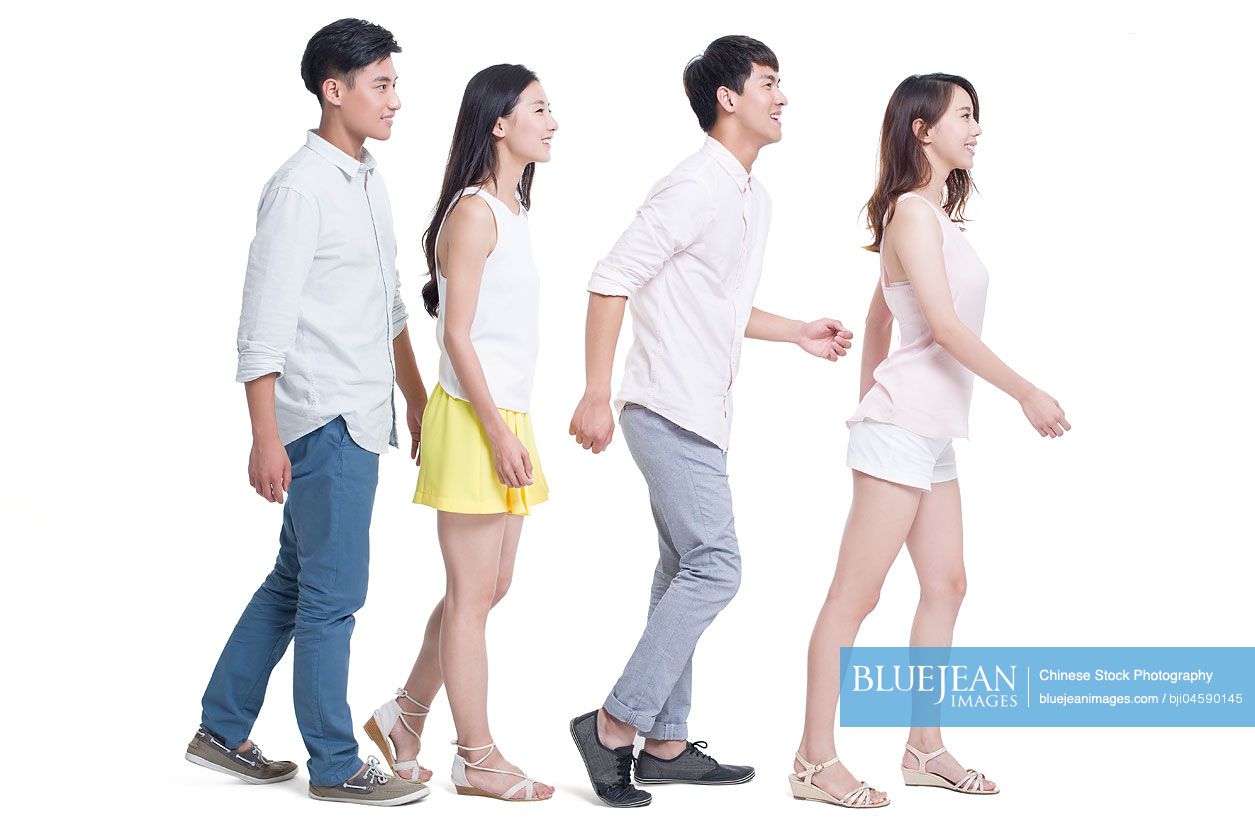 Young Chinese adults walking in a line