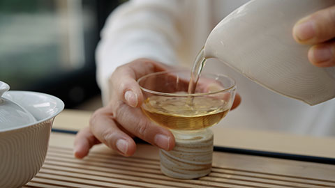 Elegant mature Chinese woman drinking tea in tea room,4K