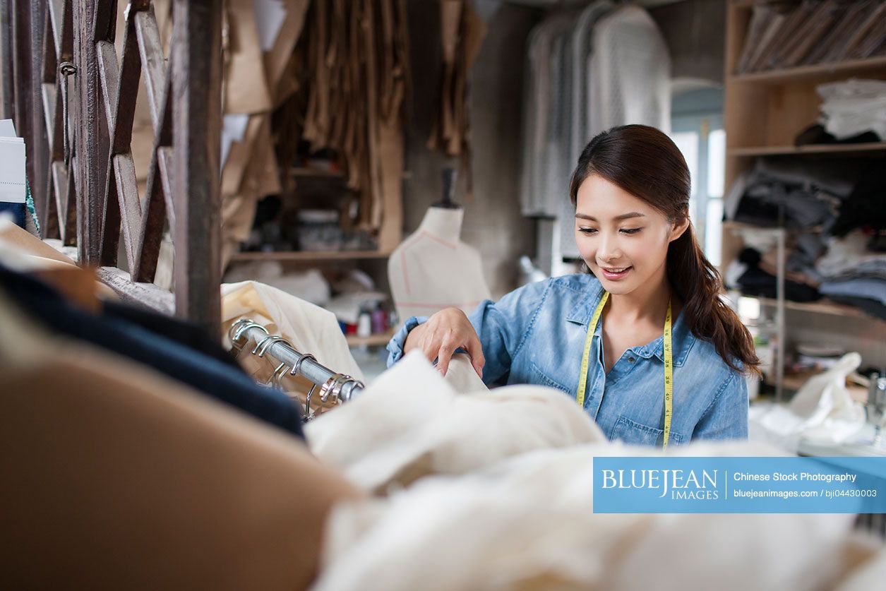 Chinese fashion designer working in studio