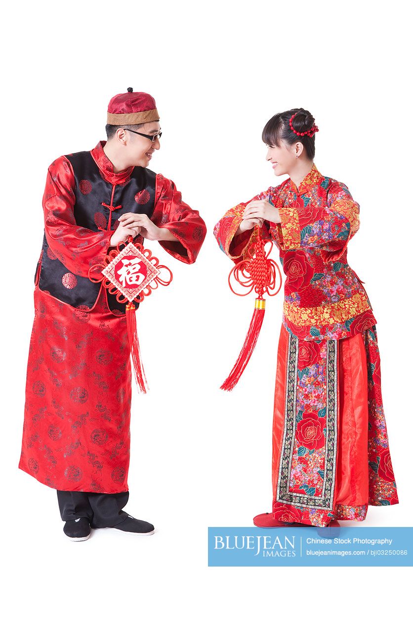 Young couple in traditional clothing greeting for Chinese New Year