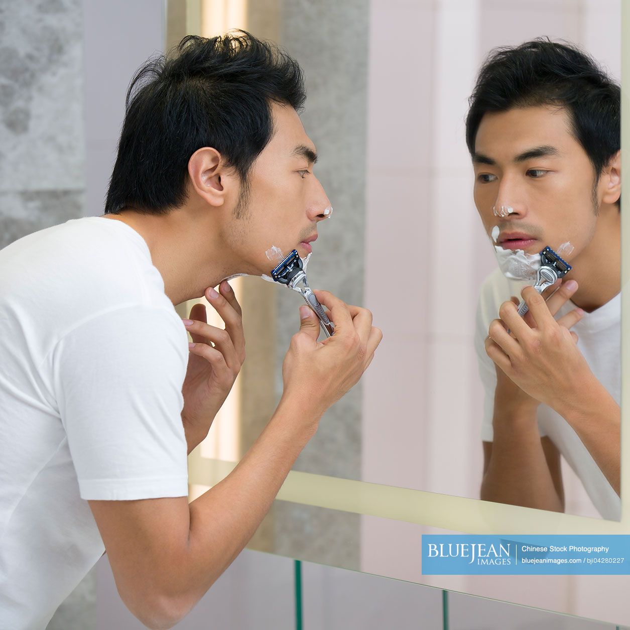 Young Chinese man shaving-High-res stock photo for download