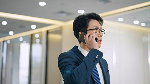 Confident Chinese businessman talking on the phone